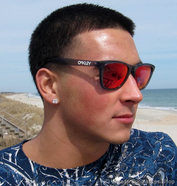 VS239: Vintage Oakley Frogskins sunglasses feature top of the line Positive Red Iridium lenses in the crystal black frame, reminiscent in style to that of ...